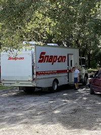 a white truck parked next to a car